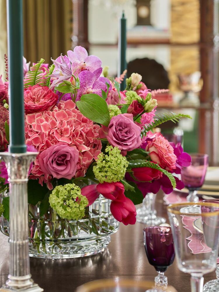 Arrangement of pink and green hydrangeas, roses, orchids, tulips, and clematis.