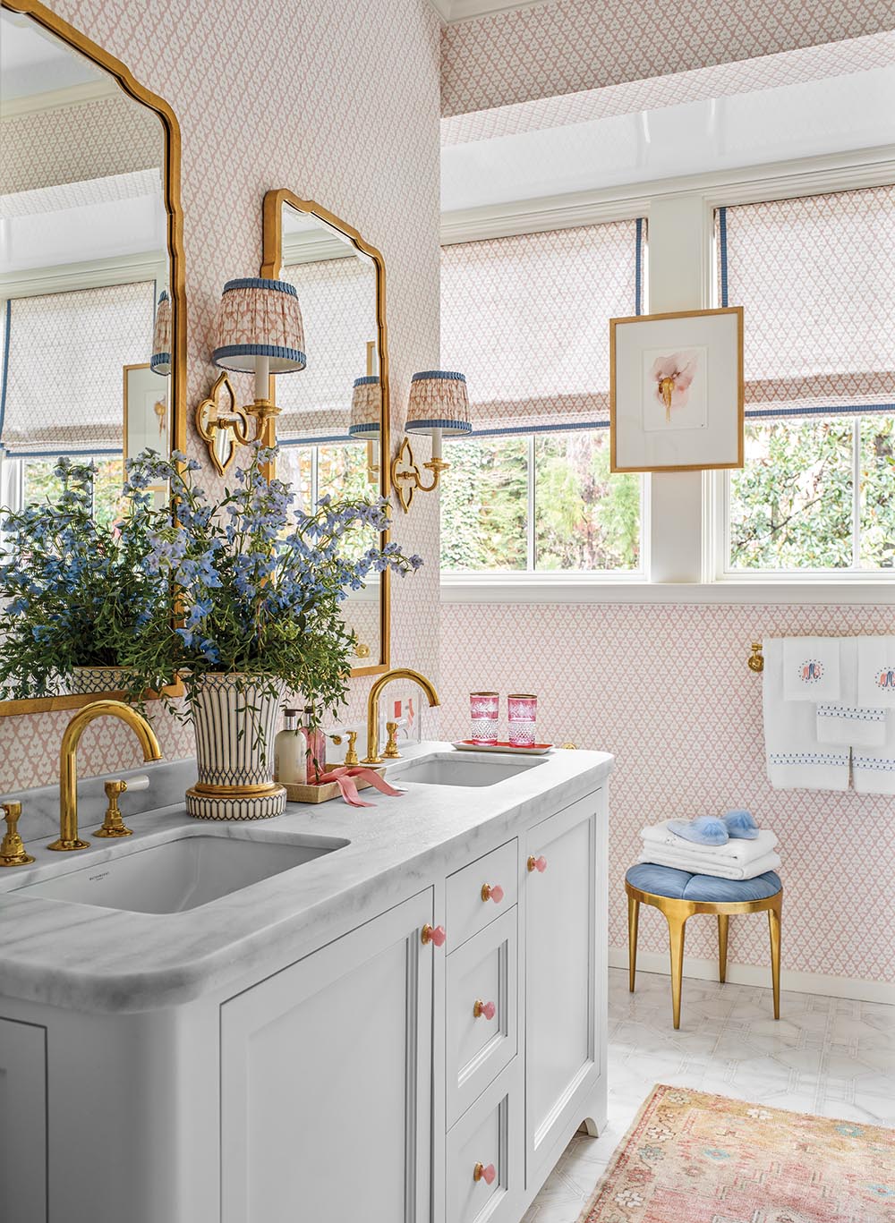 Double-sink vanity, pink wallpapered walls and matching curtains in Mallory Mathison designed en suite bathroom on second floor of the Flower Atlanta Showhouse.