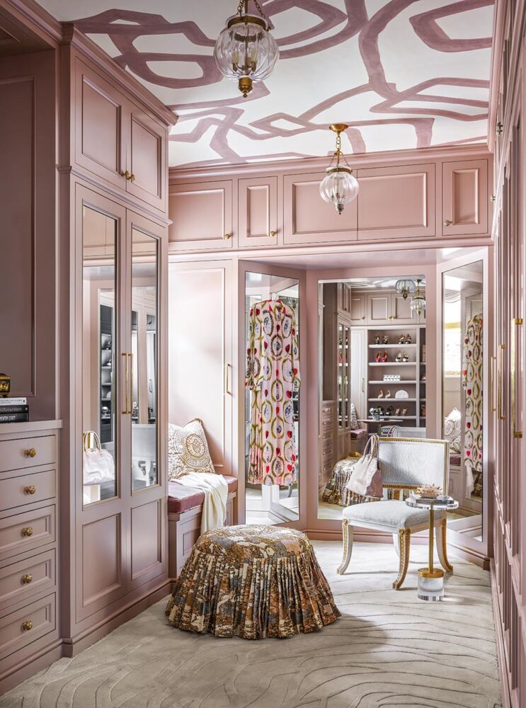 Julie Dodson designed lady's dressing room with salmon cabinets and a wallpapered ceiling.