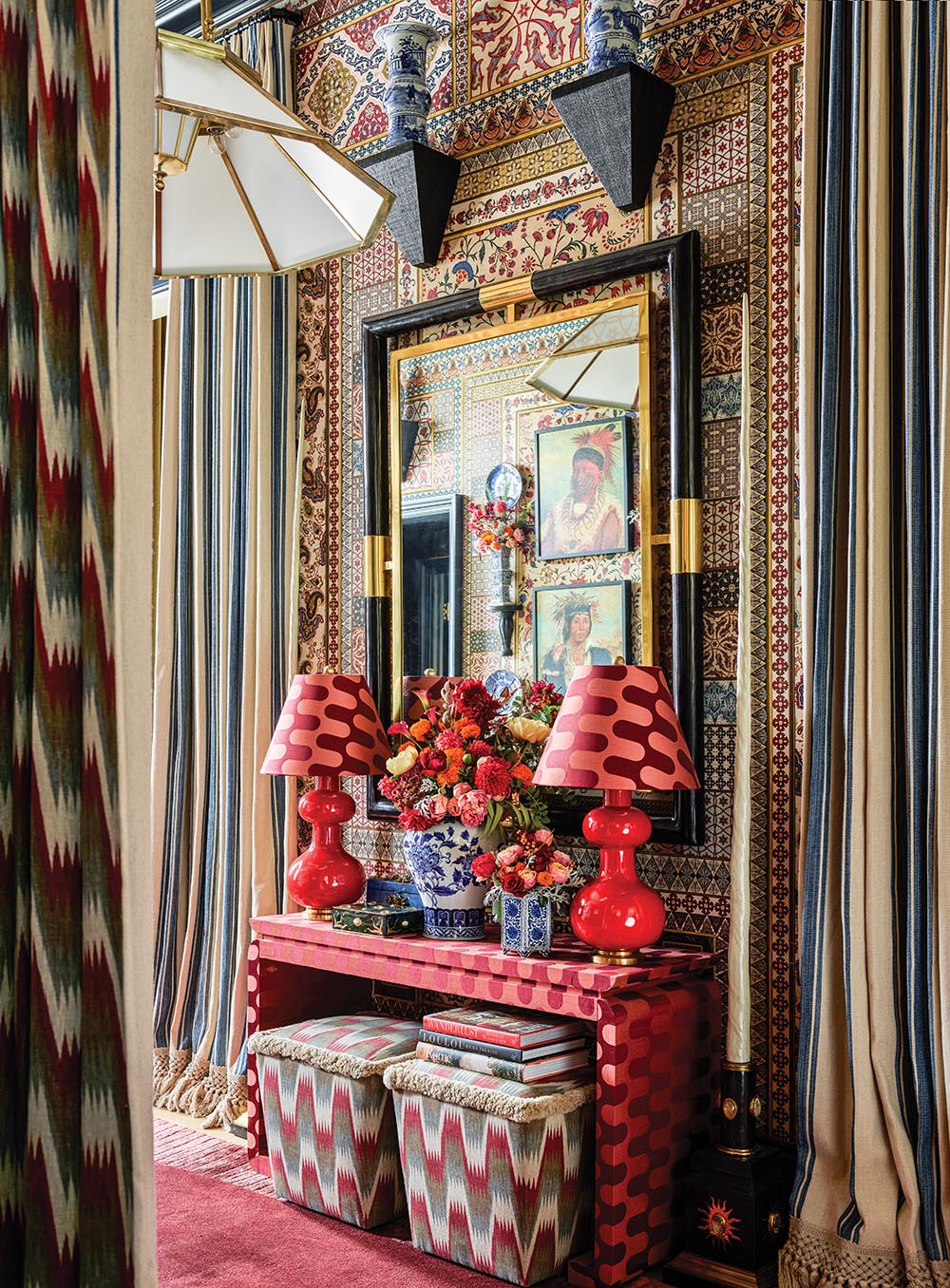 A custom console and lampshades brings in a dash of mod while echoing the color of the rug from The Rug Company. The chandelier is from Visual Comfort & Co.