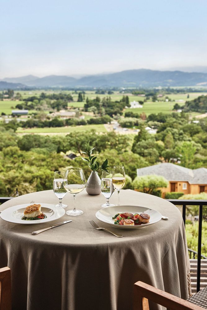 Rolling Napa Valley hills make up a picturesque view from a dining table.