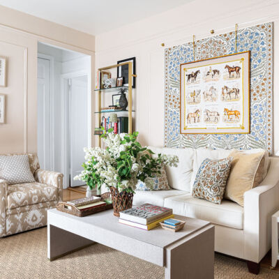 Living room in Chrissy Ritter's upper east side apartment. Arrangement of white lilacs on a linen-wrapped coffee table at center of room.
