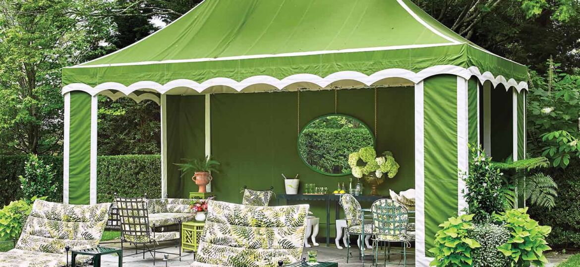 A scalloped-edge bright green tent stands next to a teal pool in lieu of a pool house.