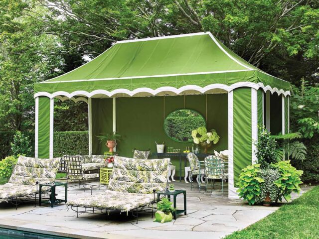 A scalloped-edge bright green tent stands next to a teal pool in lieu of a pool house.