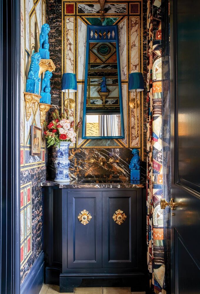 "The powder room wallpaper is based on a Venetian palazzo, and the printed velvet depicts my grandmother’s crazy quilt that I still own.” Turquoise foo dogs stand guard atop brackets.