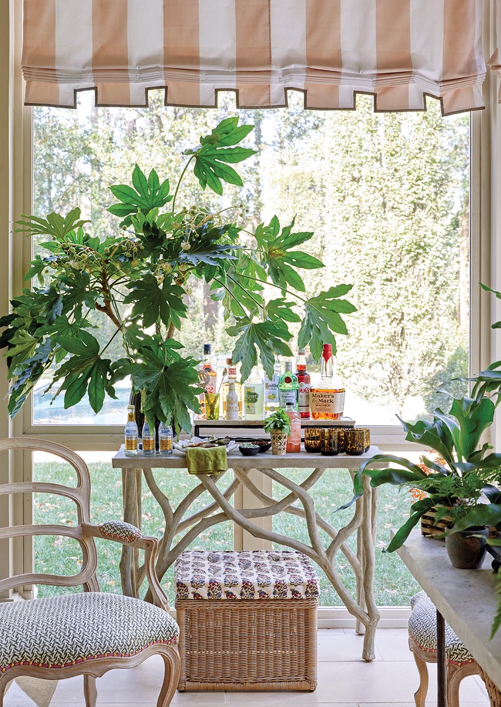 Bar set up on screened porch designed by Ashley Whittaker at the Flower Atlanta Showhouse. Large vase of flowering fatsia branches designed by Keith Robinson.