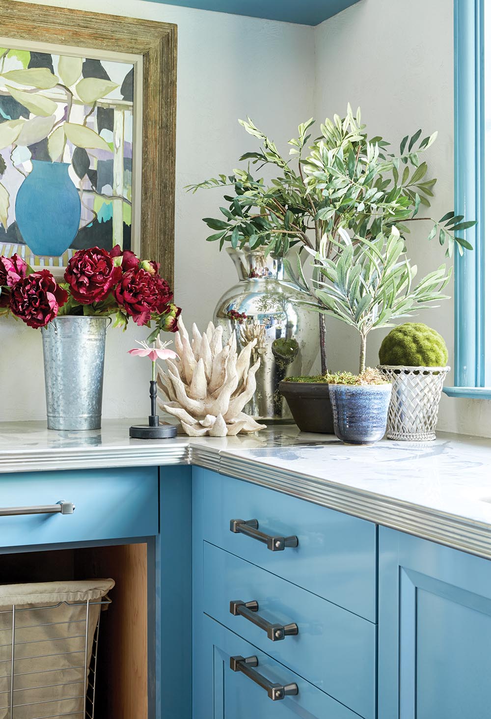 Zinc countertops on gloss, blue painted cabinets in Bunny Williams' flower cutting room at the Flower Atlanta Showhouse.