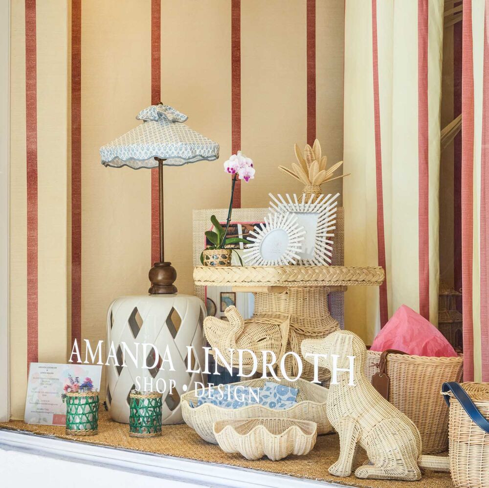 Wicker dog, shells, and elephant table in window of Amanda Lindroth's South County Road shop.