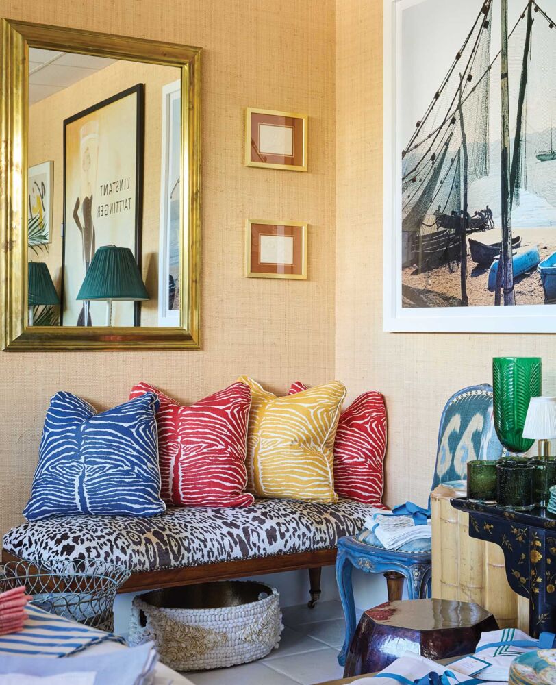 Primary colored zebra-print pillows on a leopard-print bench in Danielle Rollins Palm Beach studio.