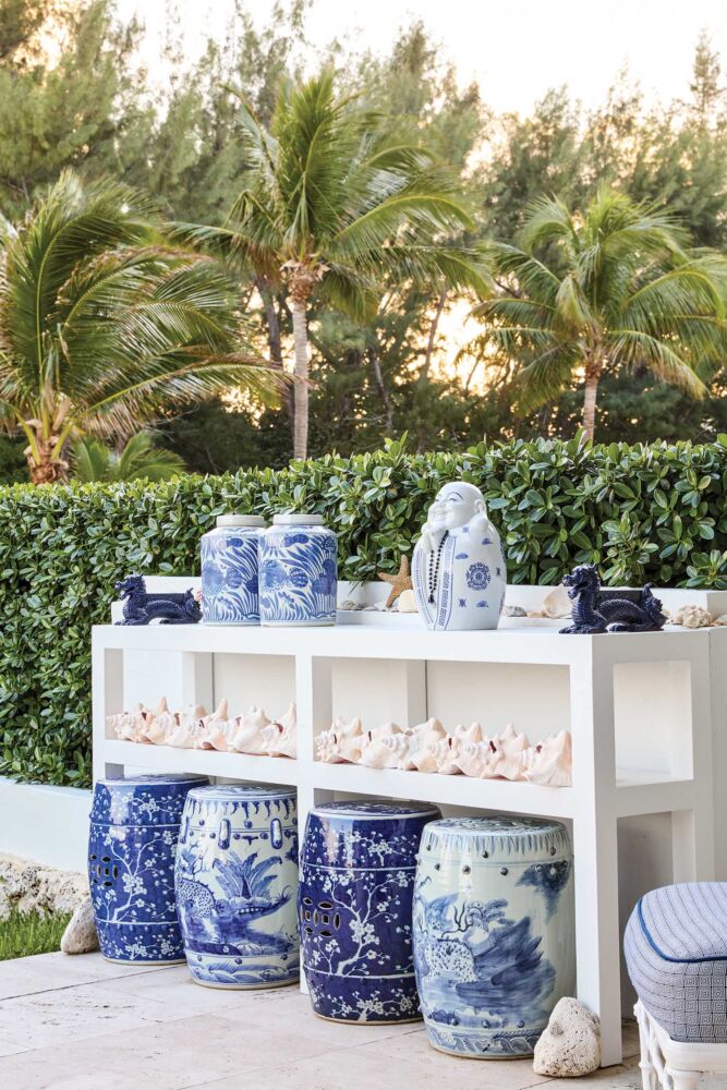 Outdoor shelf in Fernando Wong's garden stores blue and white stools, a shell collection and other blue and white porcelain.