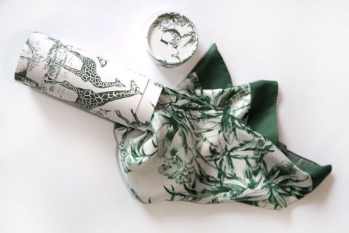 white silk scarf with a green African landscape print