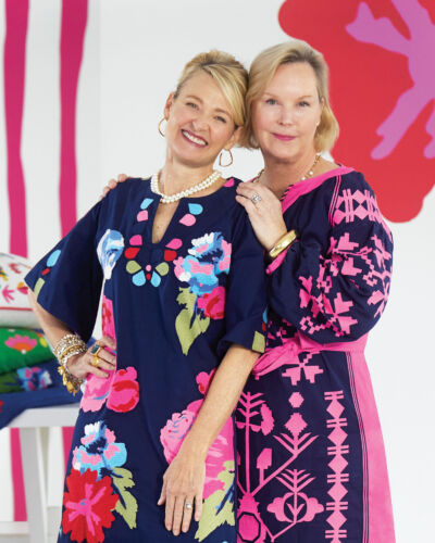 Annie Selke and Elyce Arons pose in colorful navy and pink caftans.