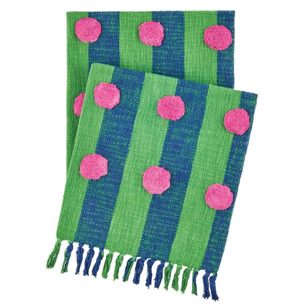 A green and blue striped blanket has pink pom poms on it.