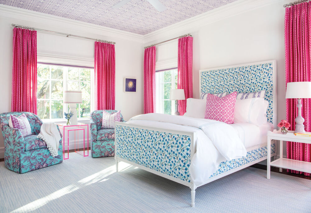 Hot pink curtains contrast a bright teal pattern bedframe.