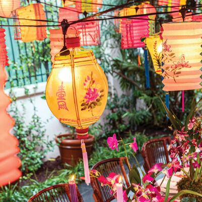 An outdoor party scene with vintage Chinese lanterns aglow
