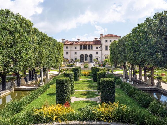 The green grounds of Vizcaya open up to Spanish Mansion.