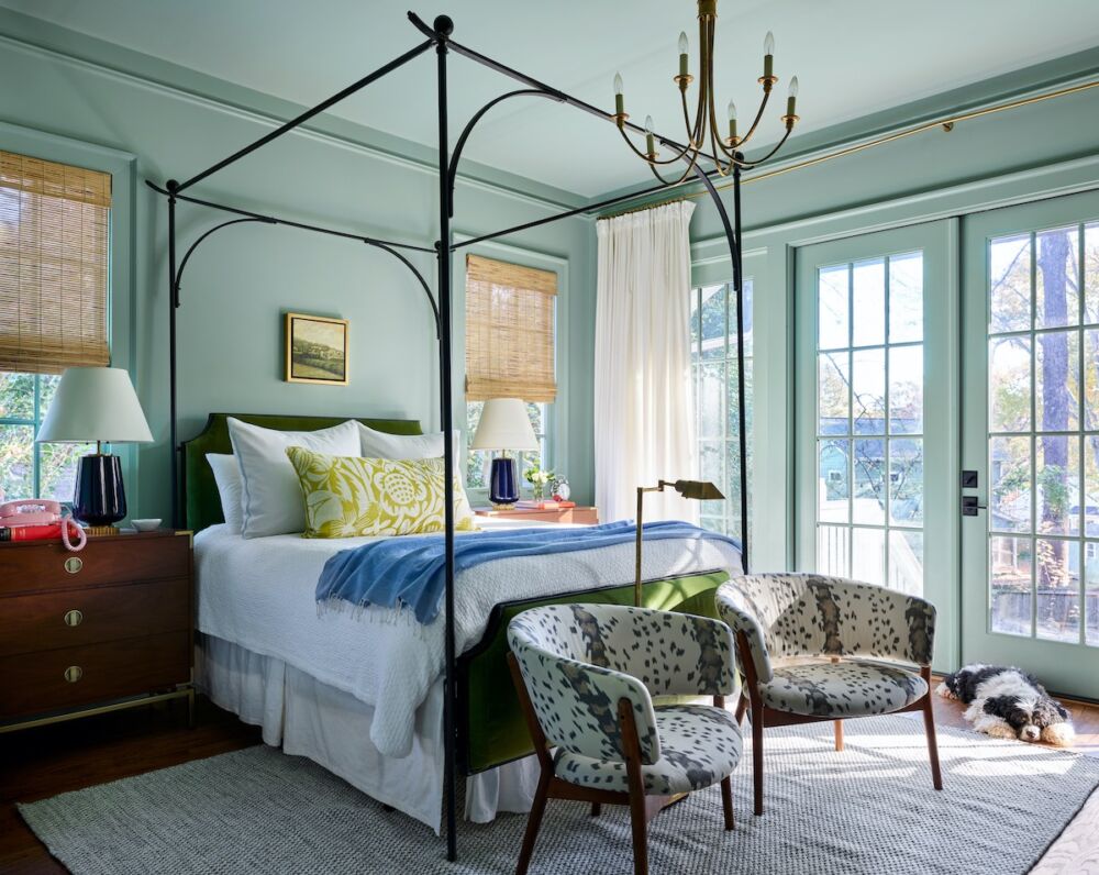 A color-wrapped main bedroom by the Atlanta designers of Gordon Dunning make sure lighting needs are always at the ready—a six-armed graceful chandelier; table lamps, and a reading lamp between two armchairs.