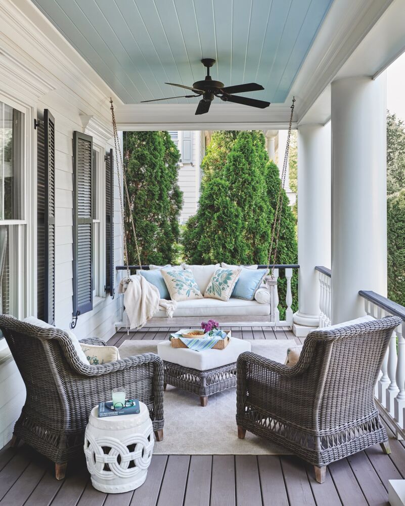 Front porch with outdoor furniture by Kinglsey Bate. The rug is by Couristan, and the throw pillows are Home Couture.