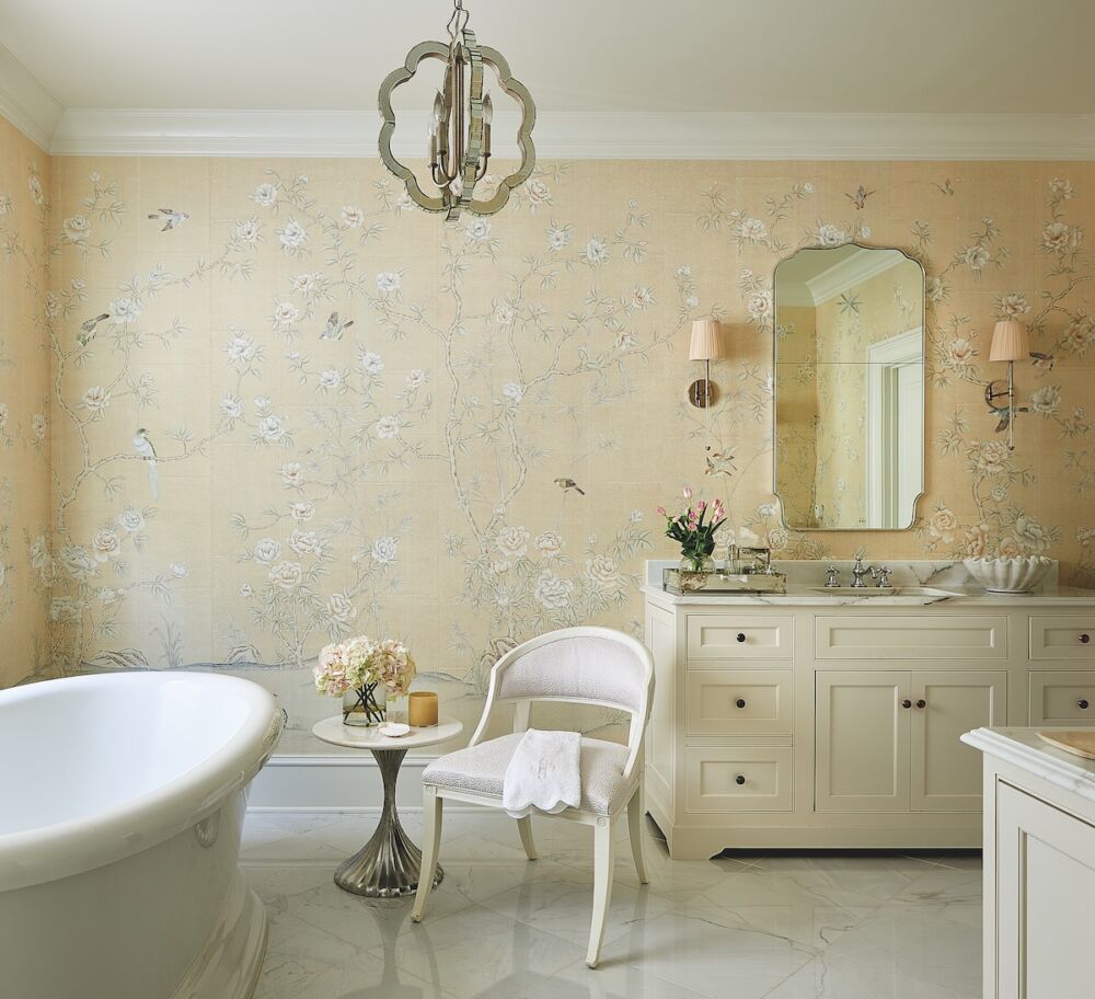 Primary bath designed by Nellie Howard Ossi with a Made Goods chandelier and Visual Comfort & Co. sconces. The side chair is the Inese by Mr. and Mrs. Howard for Sherrill and the mirror is Mirror Image Home.