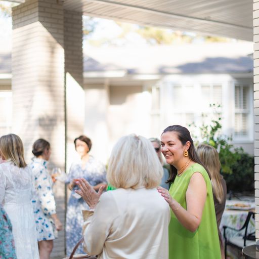 Guests gather outside at a party.