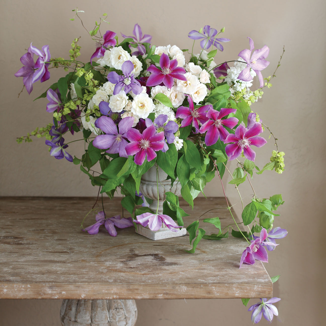 a garden-style arrangement featuring purple, violet, and white blooms by Kate Holt