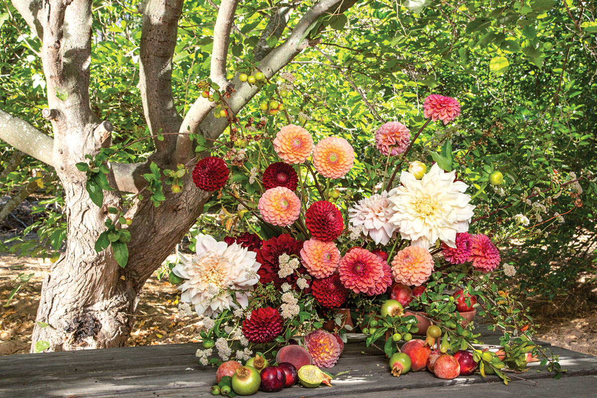 dahlia flower arrangement by Holly Vesecky of Hollyflora, in front of a background of trees