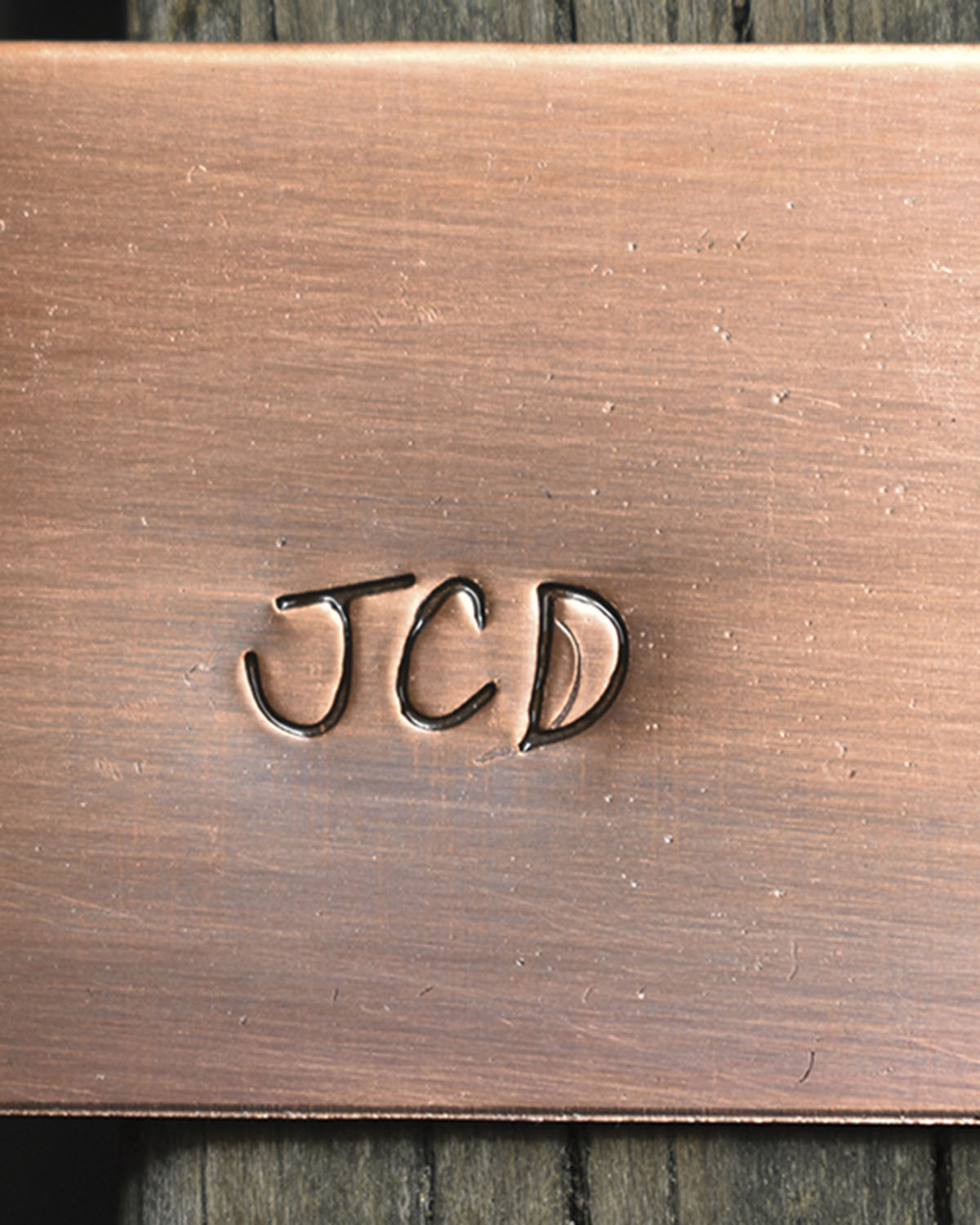 The letters JCD, the initials of a Bevolo craftsman, inscribed in brass
