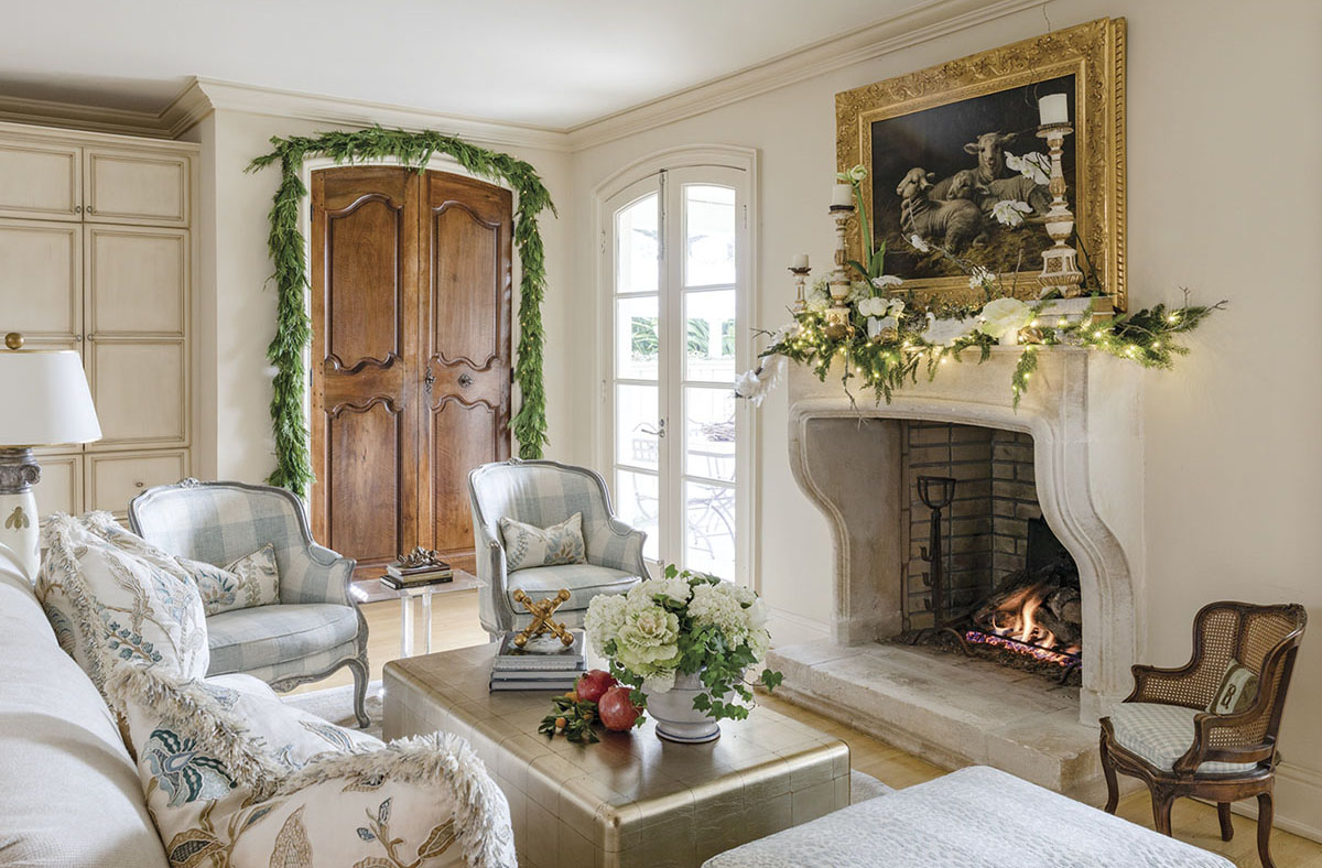 In the New Orleans home of Alix Rico and her husband, Paul, the family room’s limestone fireplace is an authentic representation of the classic château-style fixture common in Provençal architecture. Antique walnut boiserie panels were retrofitted as closet doors. Kumquats, pomegranates, and decorative cabbage enhance the garden-fresh flavor of the room, which is situated between the kitchen and the back porch.