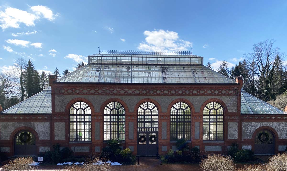 exterior view of the Conservatory on the Biltmore Estate at winter on a clear sunny day with blue skies