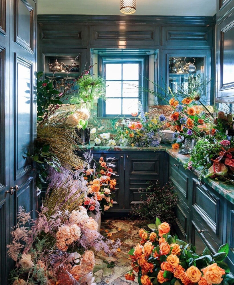 Top 20 Instagram Posts of 2020, Floral installation by @isaisafloral in a kitchen with blue lacquered cabinets by @kellywearstler