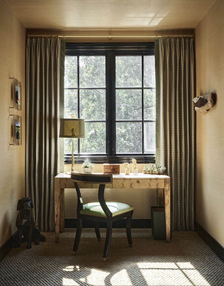 boy's homework desk by a window flanked by green drapes