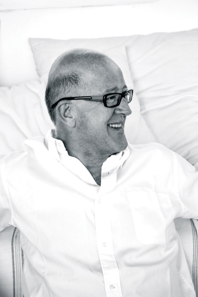 black-and-white portrait of Veere Grenney wearing a white button up and glasses