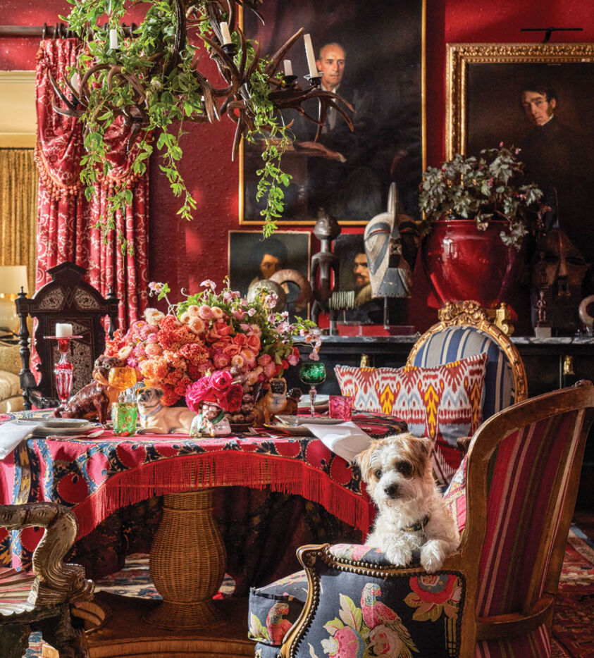 Michelle Nussbaumer’s moody red dining room, decorated with floral arrangements by Jimmie Henslee
