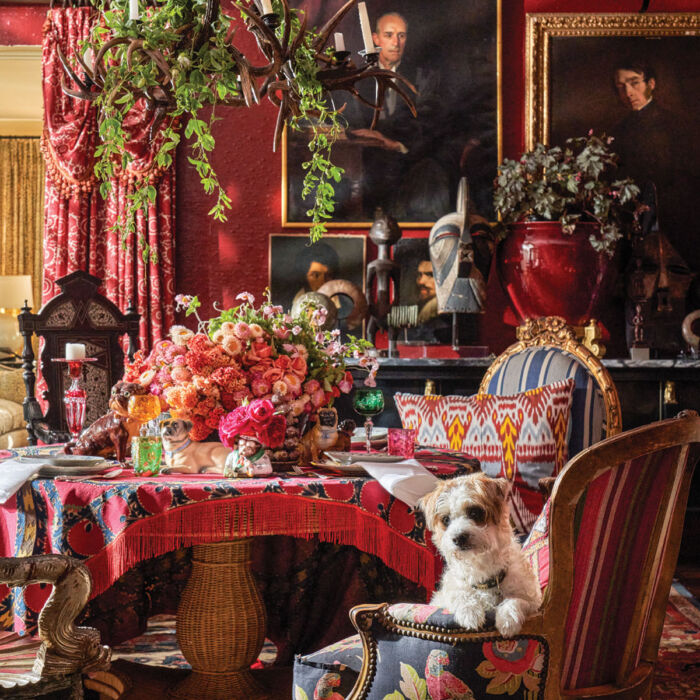 Michelle Nussbaumer’s moody red dining room, decorated with floral arrangements by Jimmie Henslee