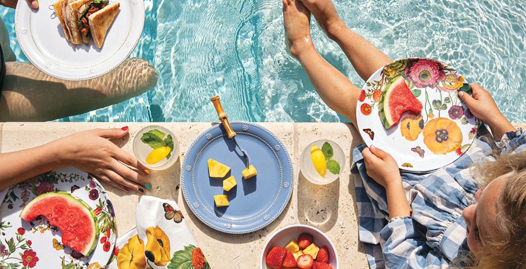 poolside picnic scene featuring floral-patterned melamine plates