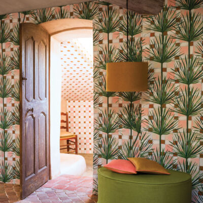 a room papered in a tropical leaf print from Pierre Frey