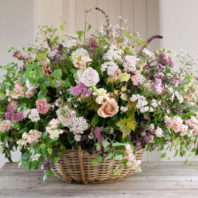 large garden style arrangement in a basket by British floral designer Philippa Craddock