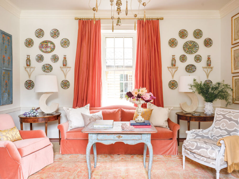 living room designed by Janie Molster, velvet sofa and club chair, plate hanging, coral color decor scheme