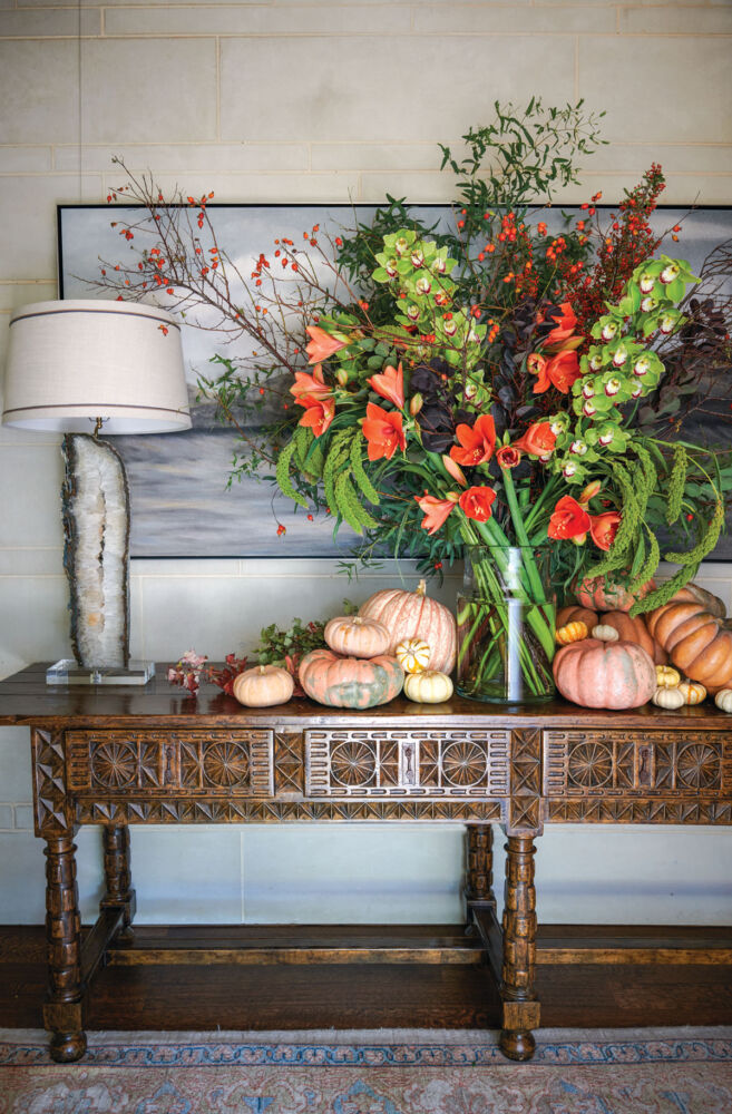 console table with a grand autumn floral display with pumpkins
