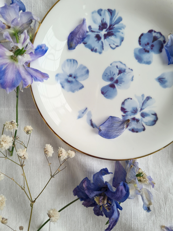 blue-and-white floral trinket dish by artist Safiyyah Choycha, styled with blue flowers