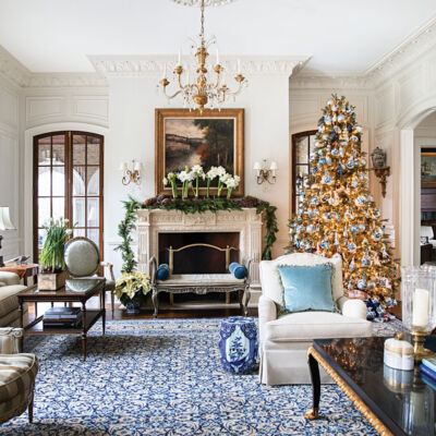 blue-and-white living room decor, Christmas tree, mantle garland, potted amaryllis flowers