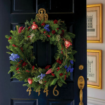 Evergreen Christmas wreath with roses, lilies, and other fresh flowers