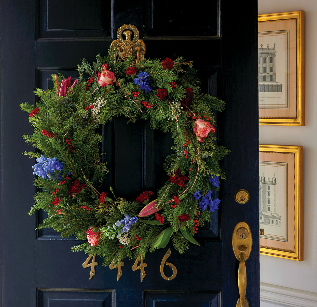 Evergreen Christmas wreath with roses, lilies, and other fresh flowers