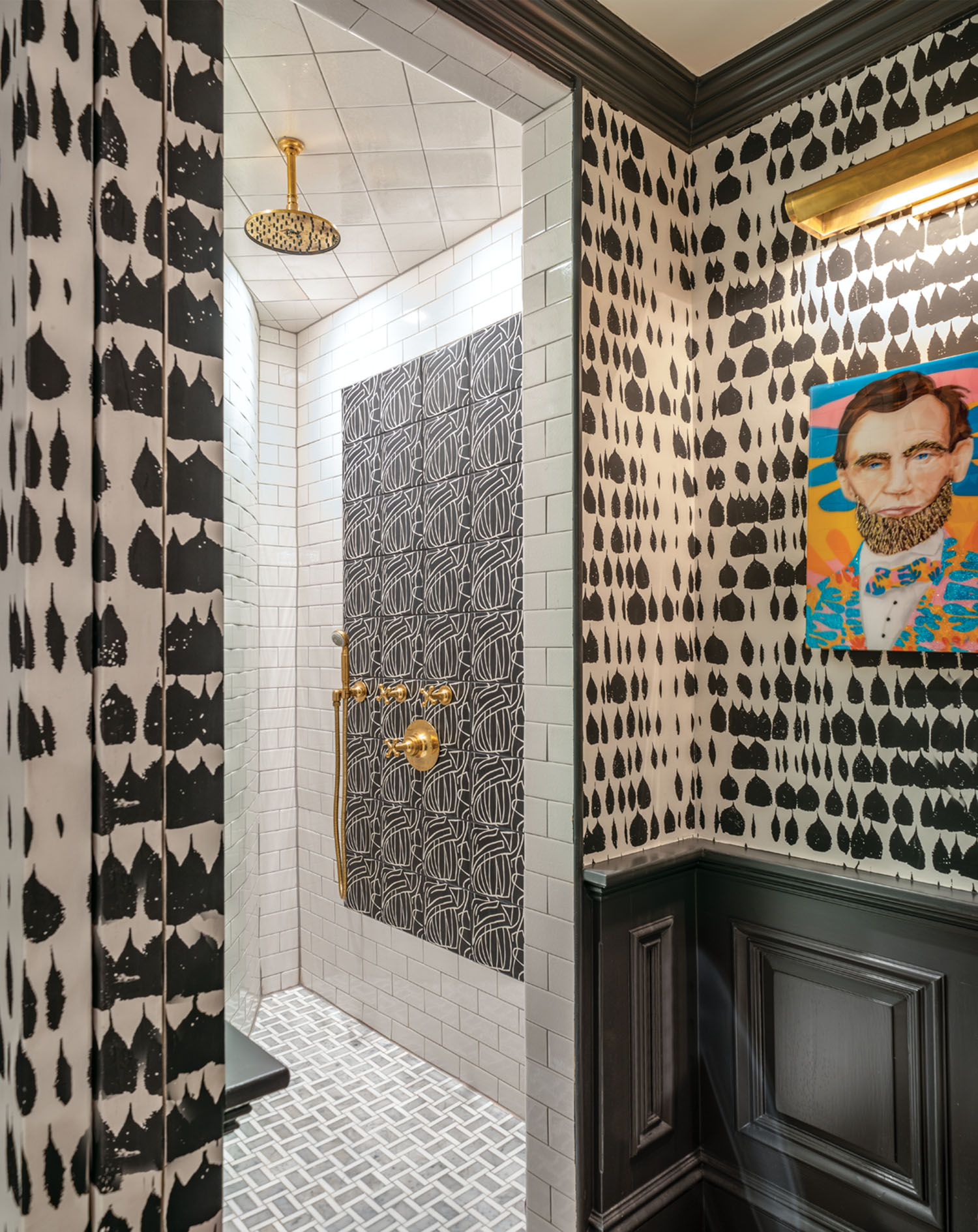 Graphic black and white wallpaper outside the tile shower of a bathroom designed by Liz Caan.