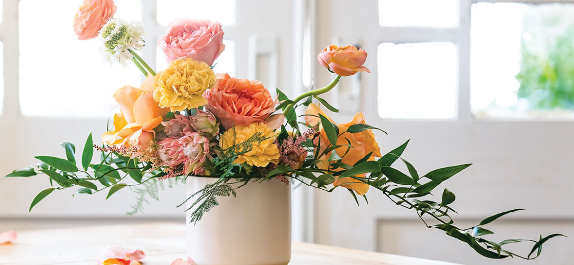 vibrant arrangement of roses, carnations, and proteas