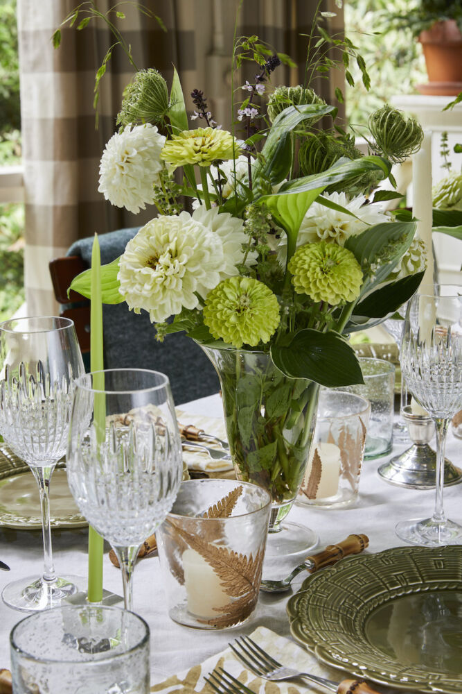 Green and white flower arrangement and table setting