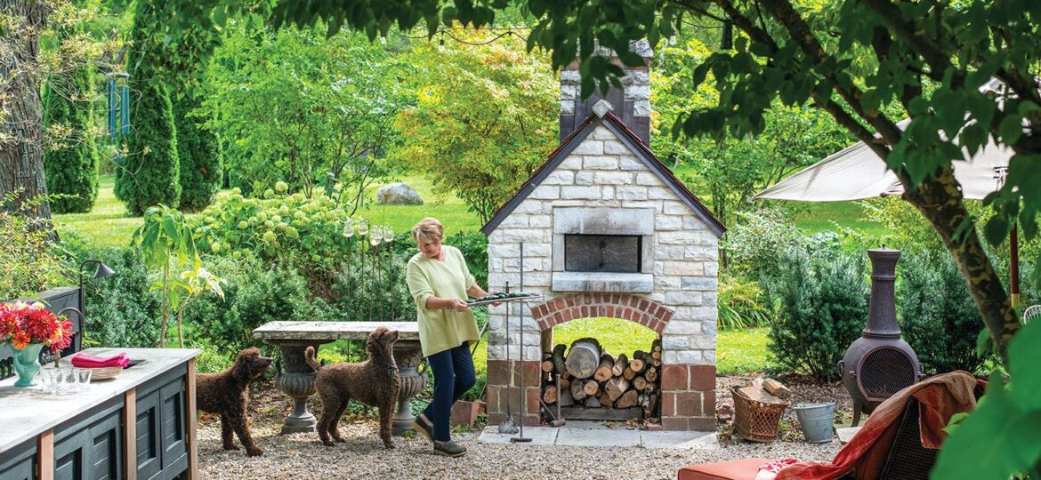 Maria with dogs in outdoor kitchen