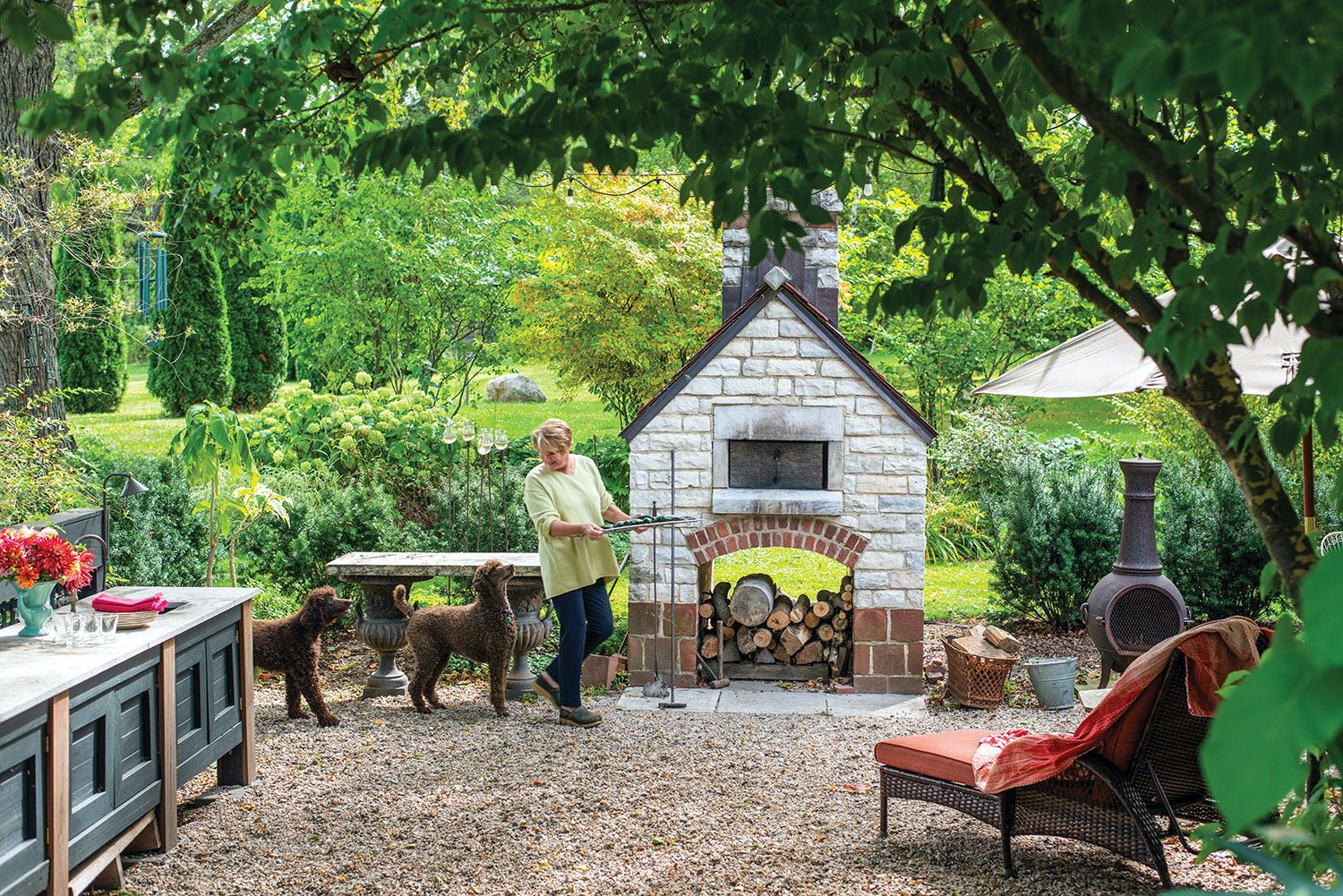Maria with dogs in outdoor kitchen
