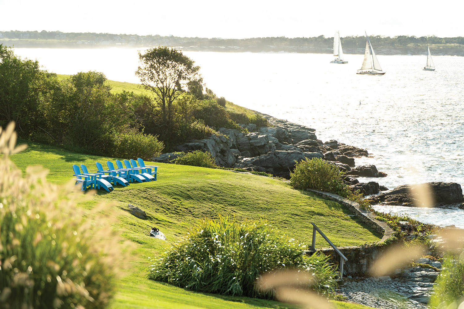 Water view from the Hamiltons’ Newport home are best enjoyed from Adirondack chairs perched on the edge of the property