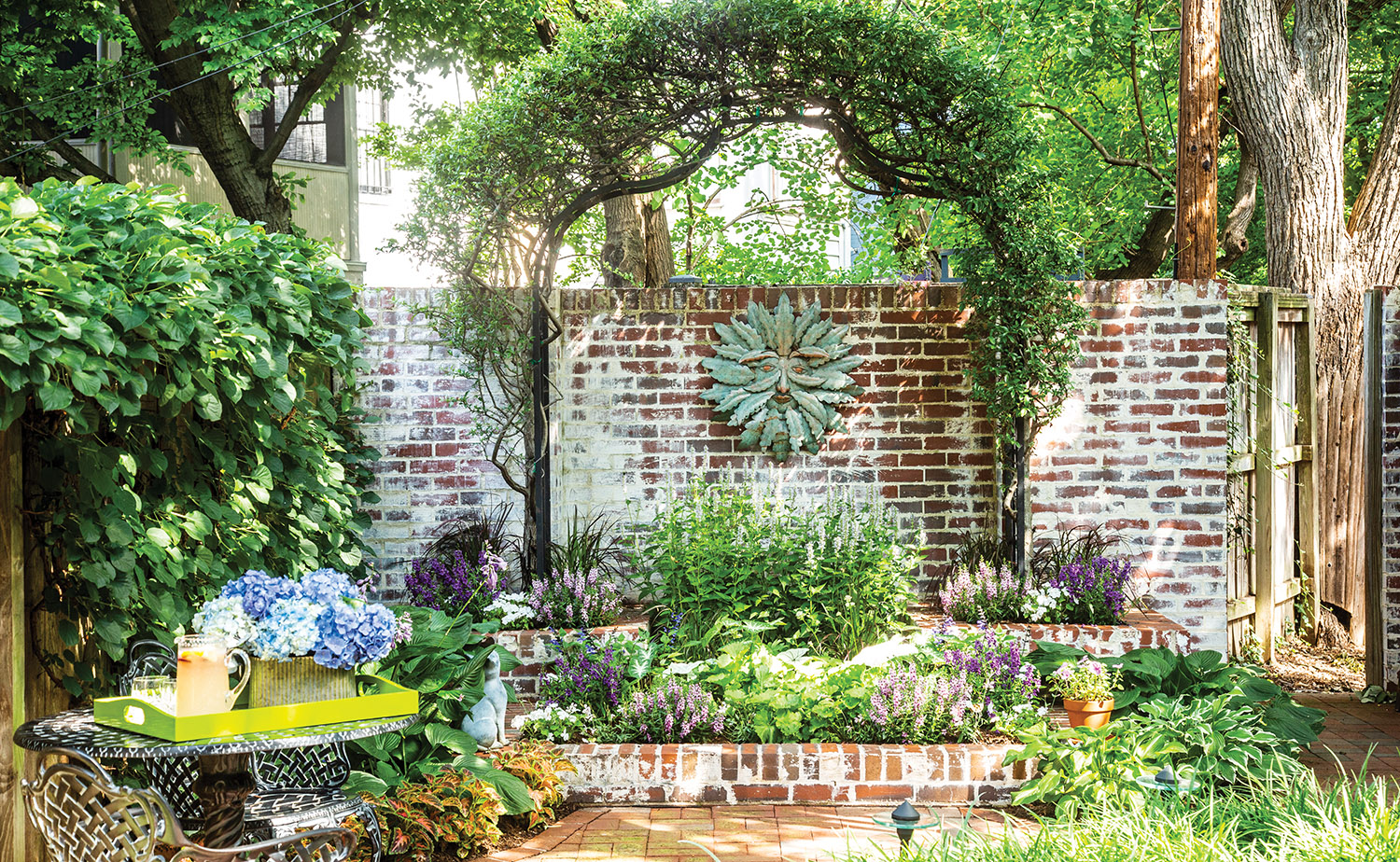 Capital Hill townhouse garden with brick wall and arbor